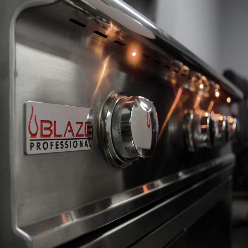 Stainless steel control panel with Blaze Professional logo and amber-lit knob