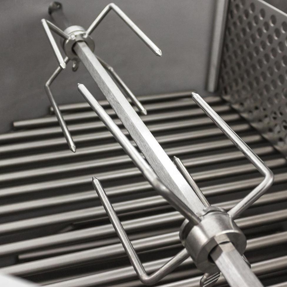 Stainless steel rotisserie spit with dual forks mounted over grill grates