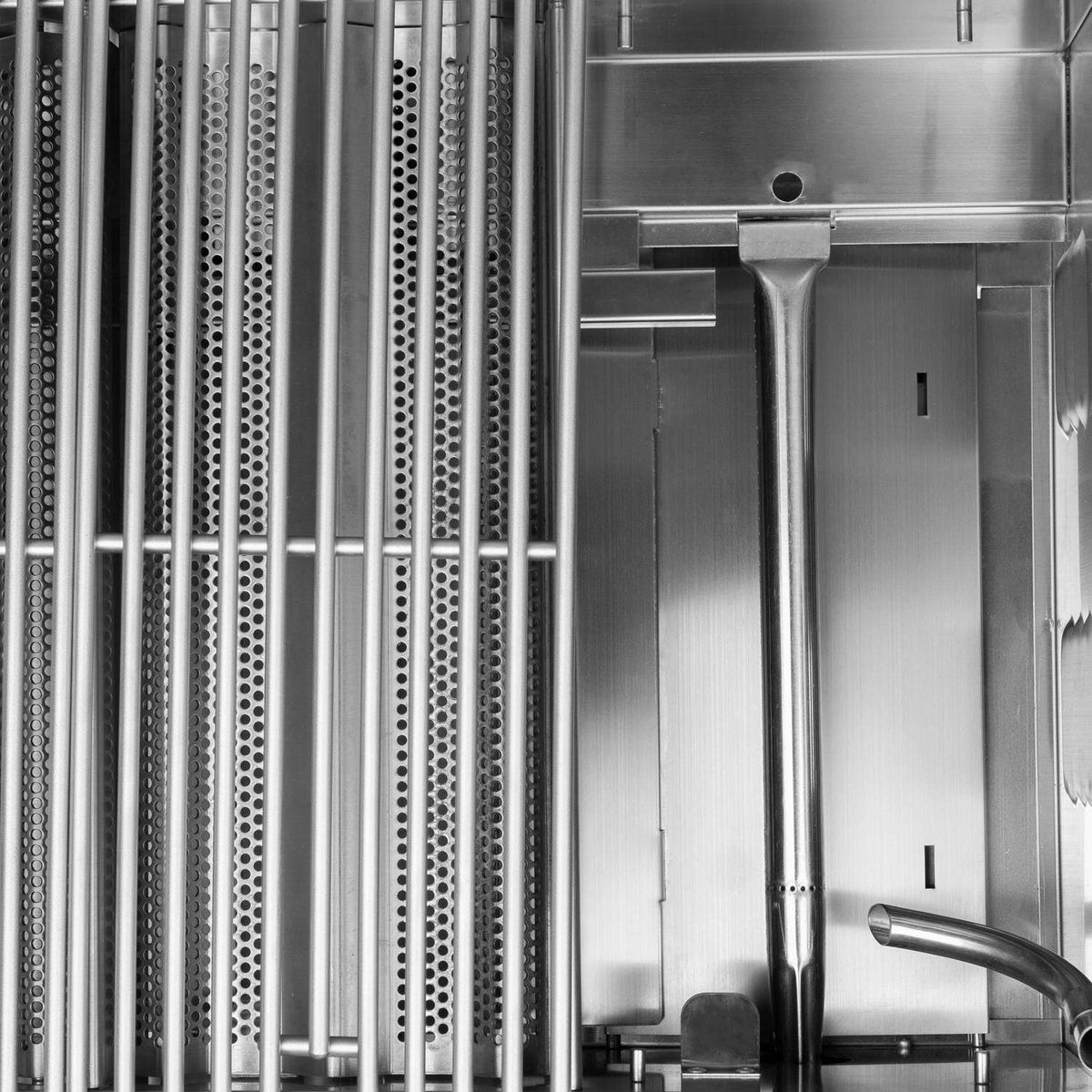 Stainless steel grill interior with burner flame tubes and control valve area