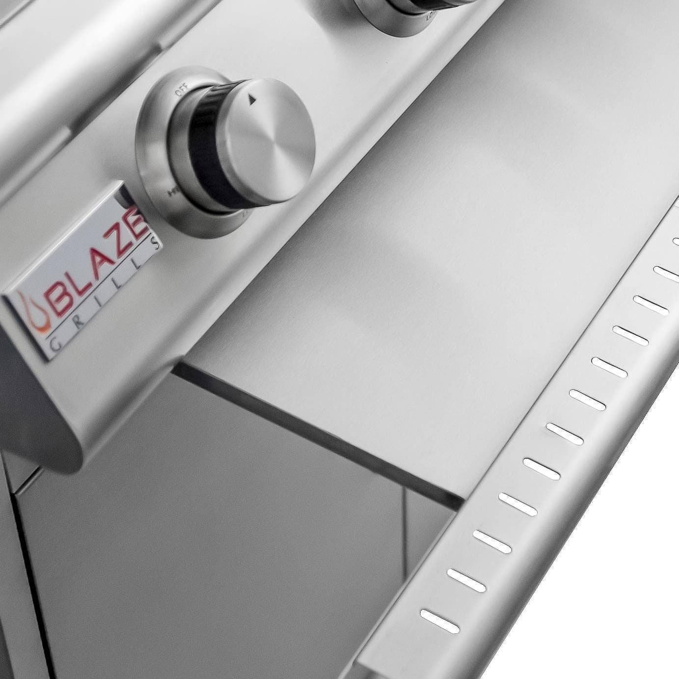 Stainless grill control panel with four round knobs and BLAZE logo