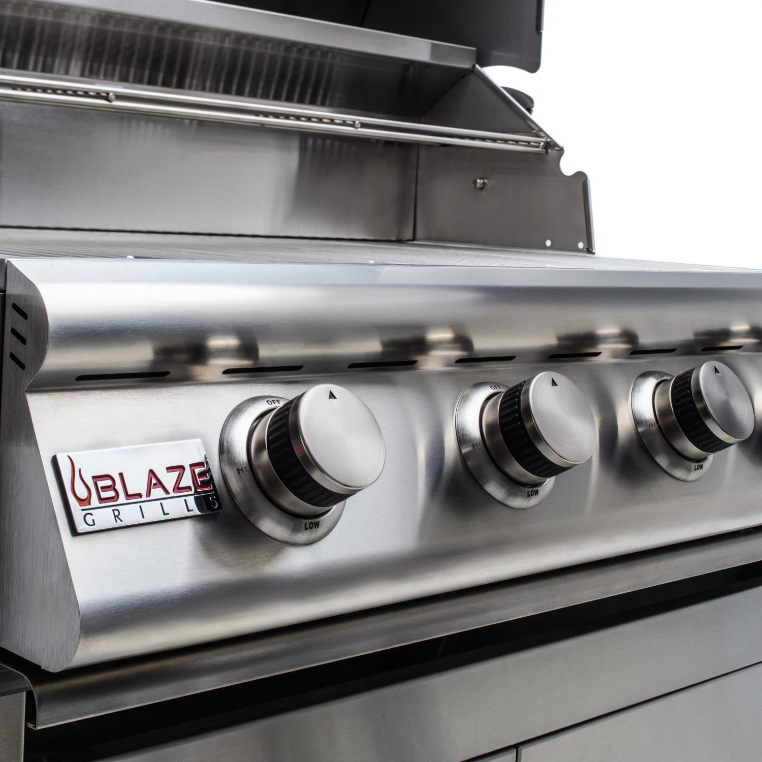 Front view of stainless steel grill with four knob controls and Blaze panel