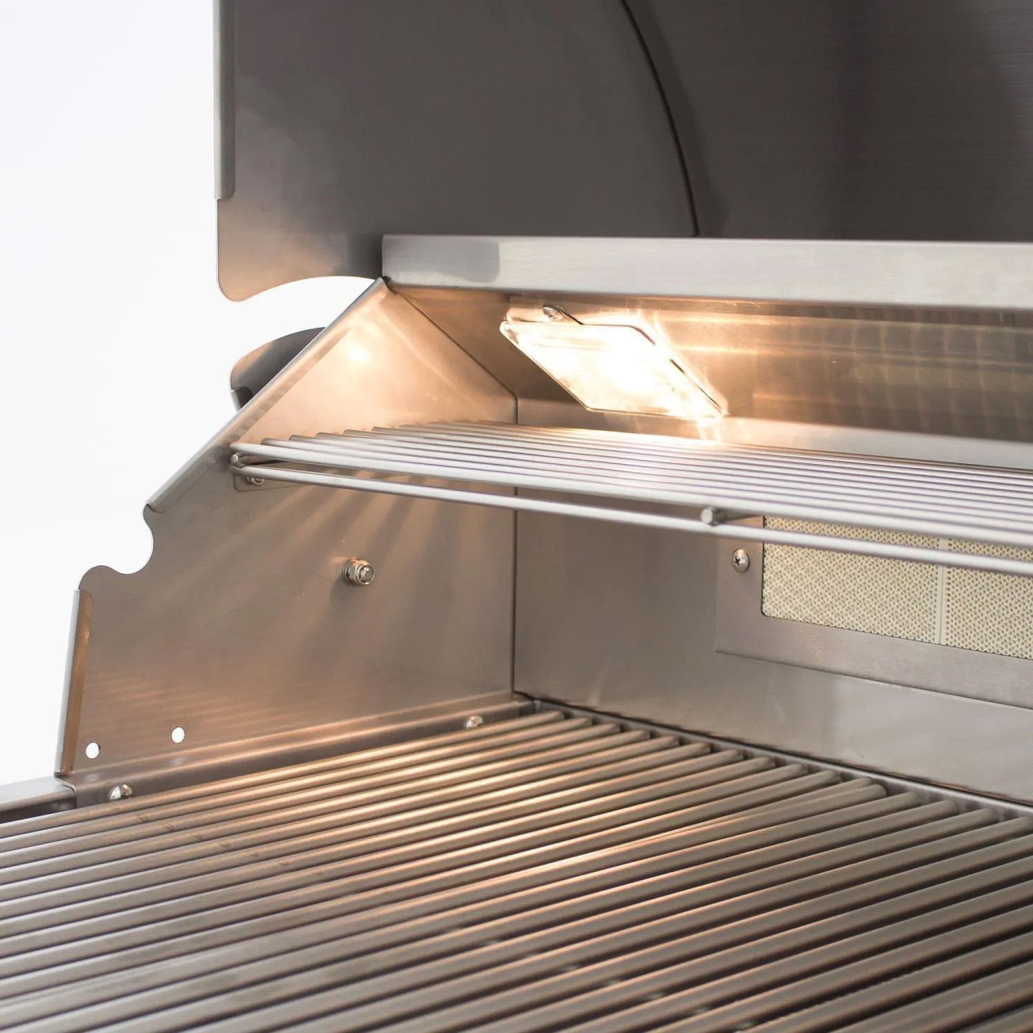 Open stainless steel grill hood showing the burner cover and cooking grate
