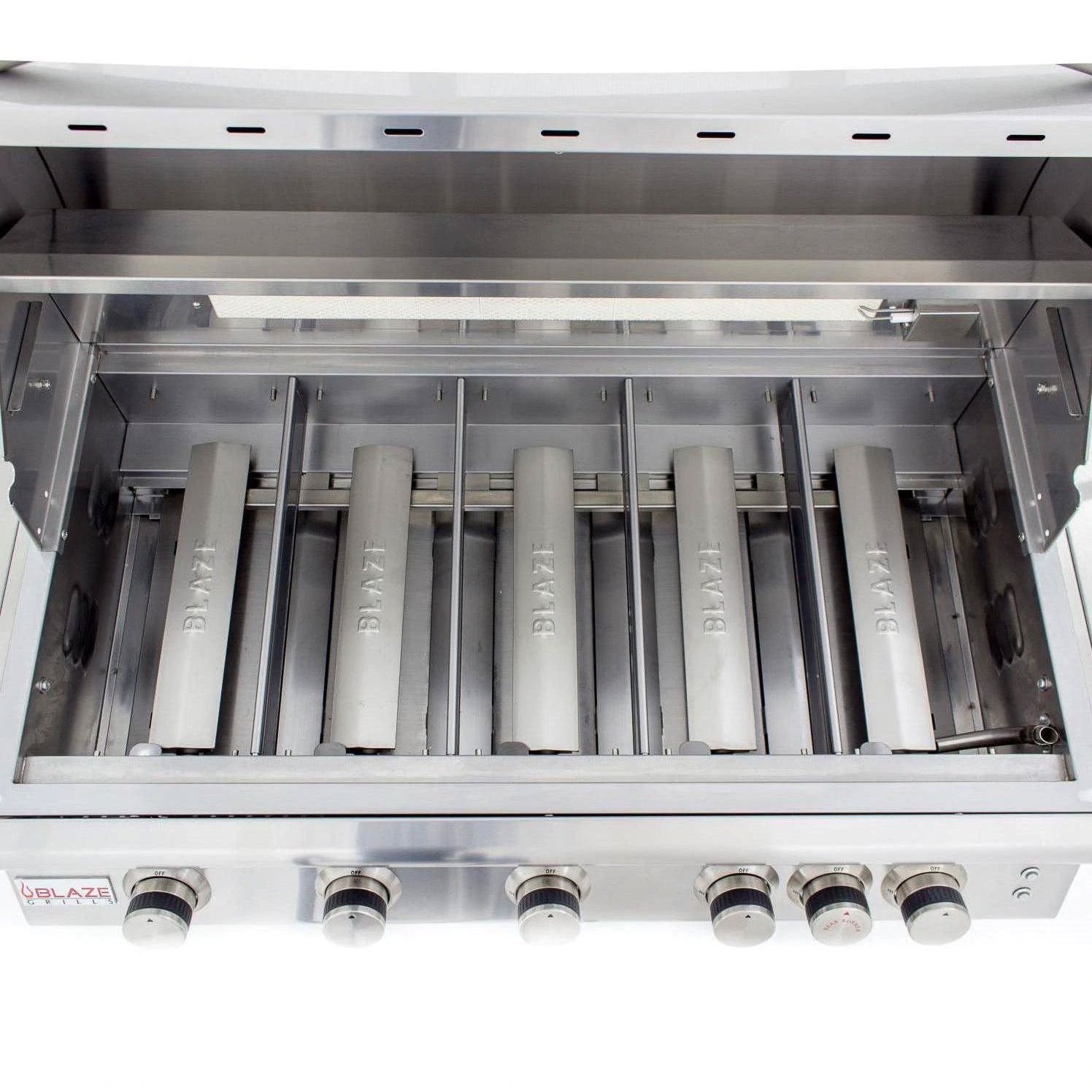 Stainless steel burner tubes inside grill firebox with front control knobs