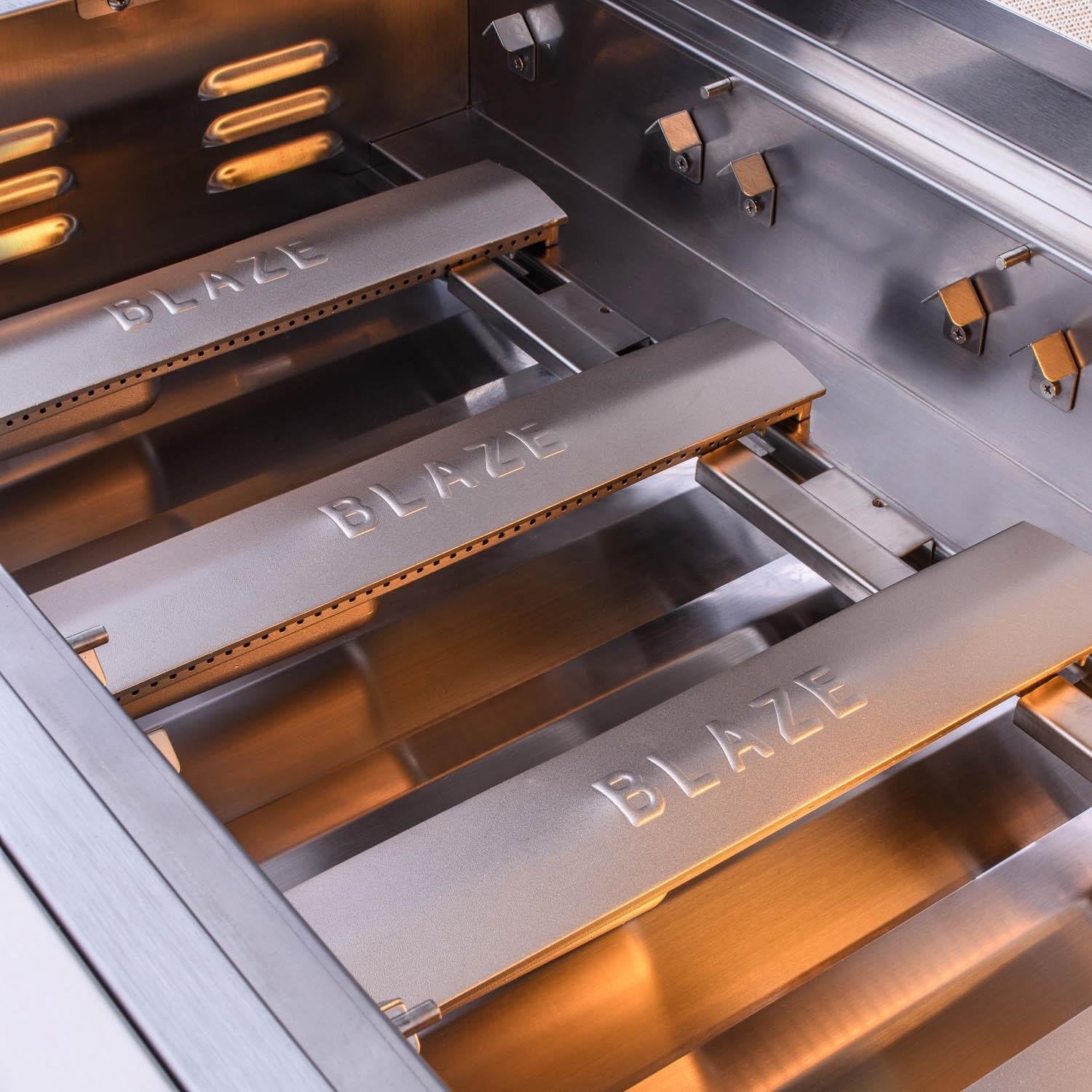 Built-in stainless steel grill with open hood and BLAZE logo panel