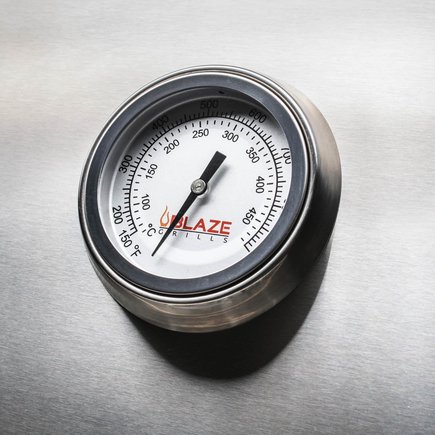 Stainless steel grill temperature gauge with Blaze logo and circular dial