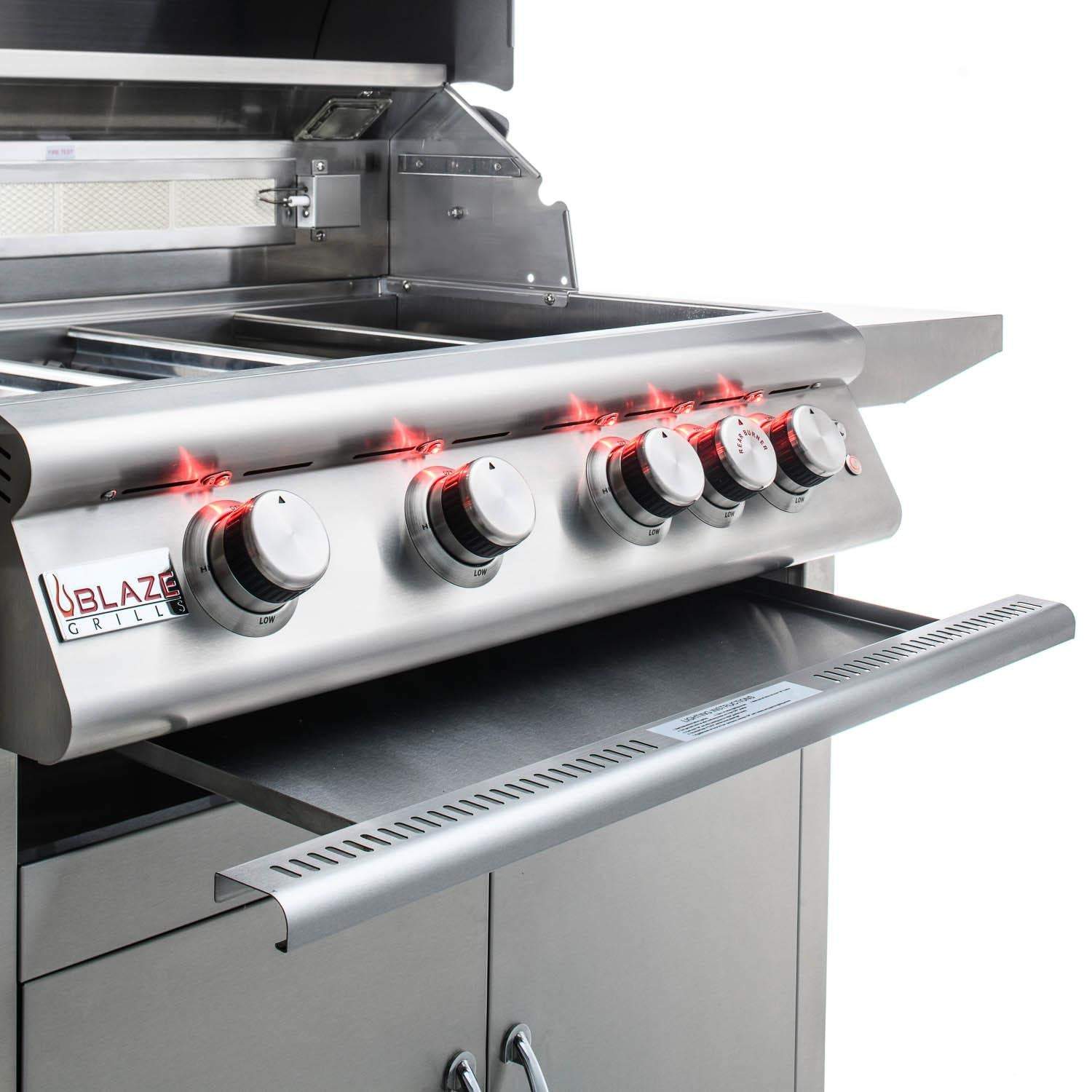 Stainless steel grill with four control knobs and open cooking area