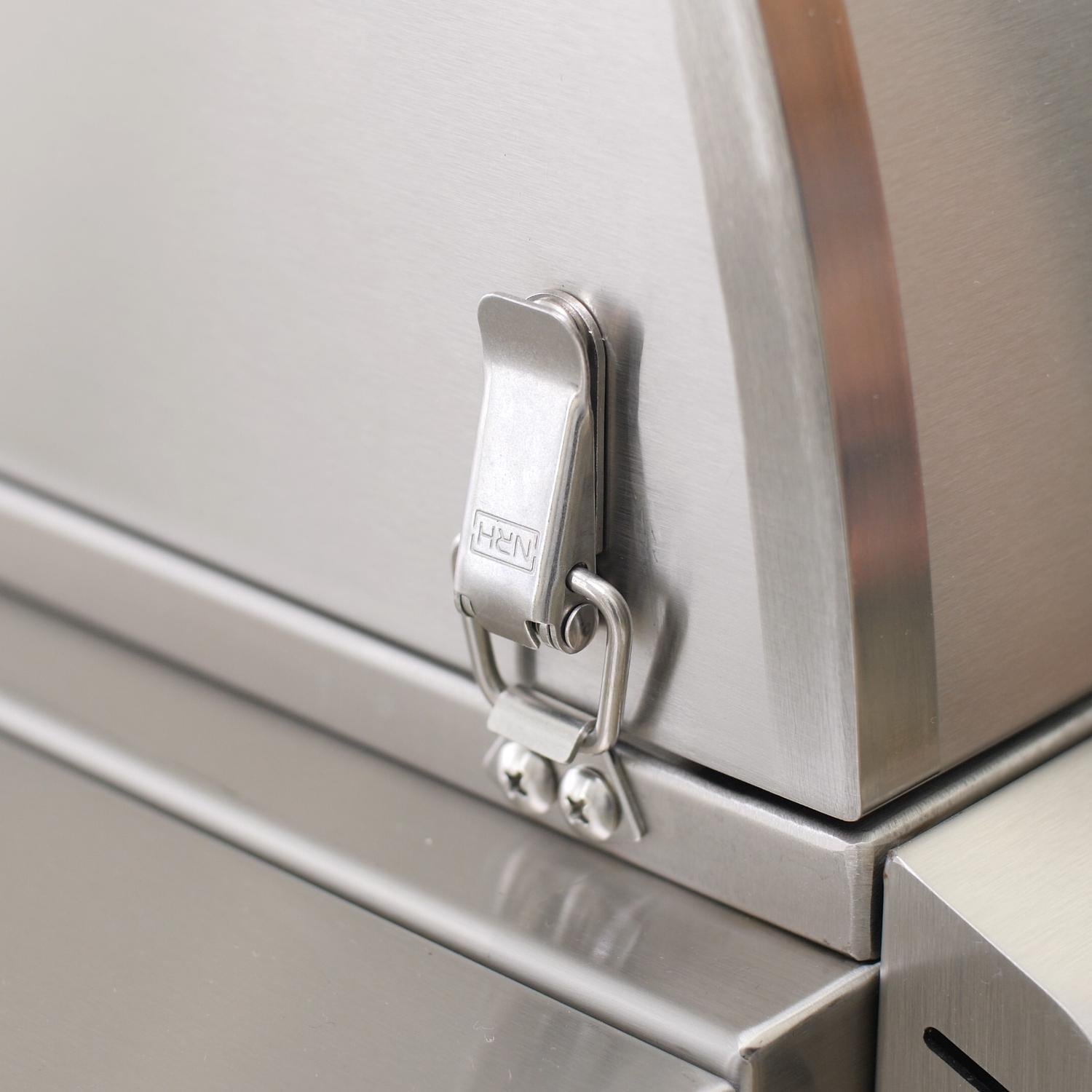 Stainless grill cabinet latch and handle detail on a built-in natural gas unit.