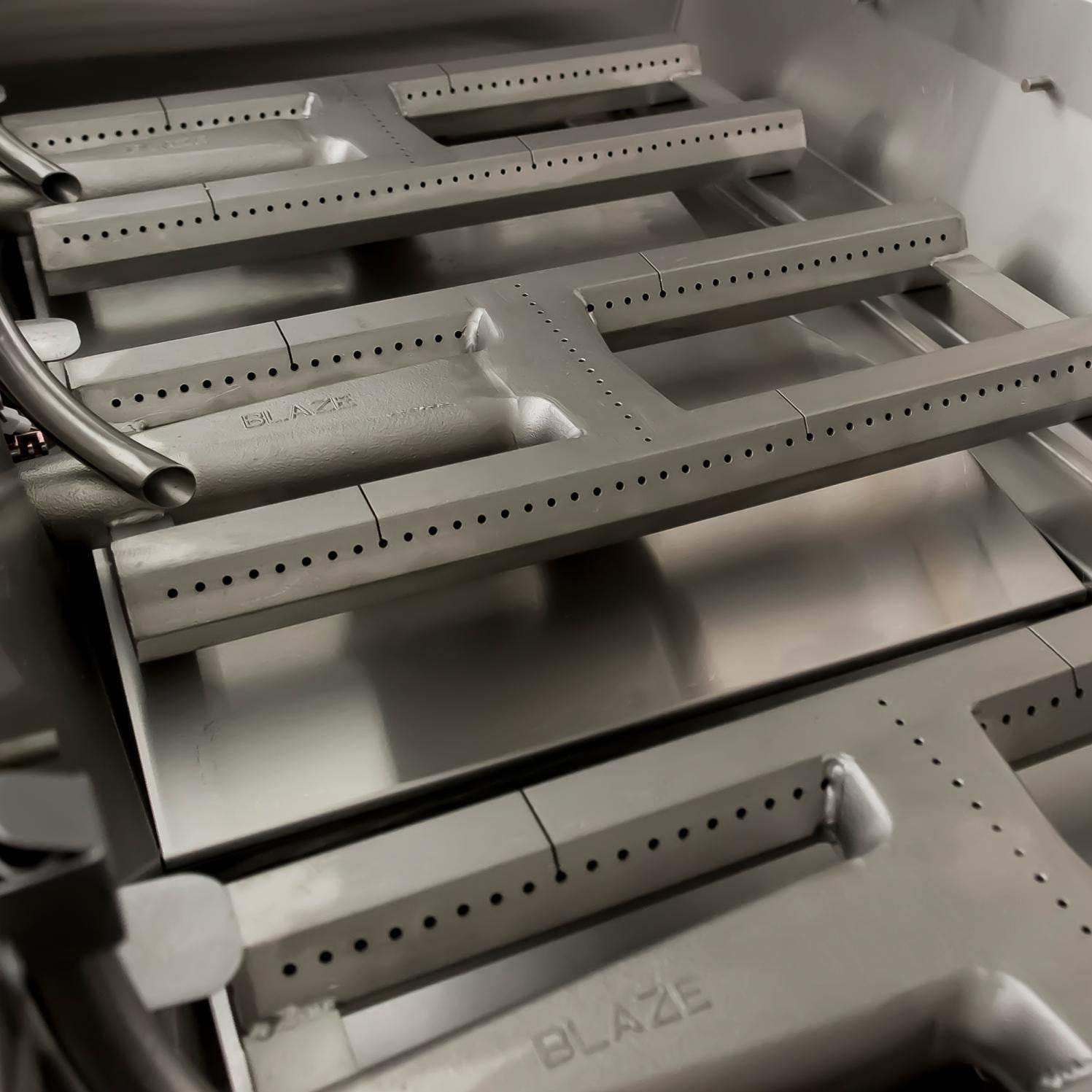 Built-in stainless steel grill burner tray with flame ports and control area