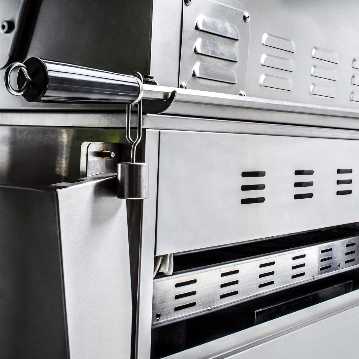 Stainless steel grill control area with burner control panel vents and side hardware