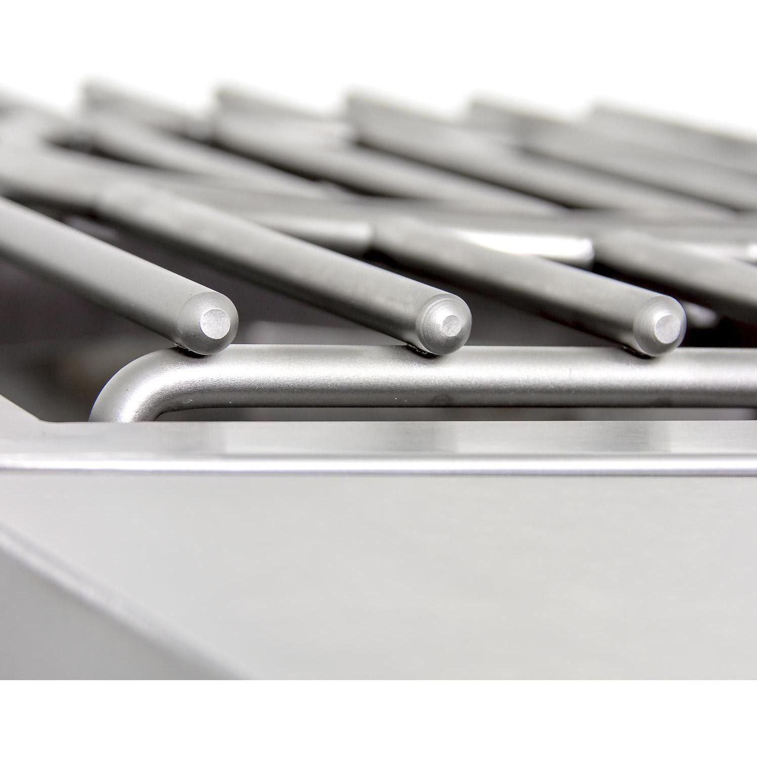 Close-up of stainless grill grates with parallel metal bars and burner openings