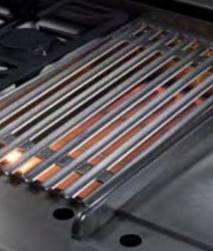 Gas range grill area with glowing metal tube burners