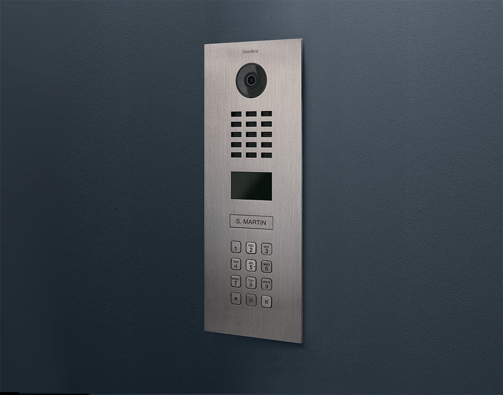 Stainless steel video intercom panel with camera, speaker grille, and keypad on wall mount