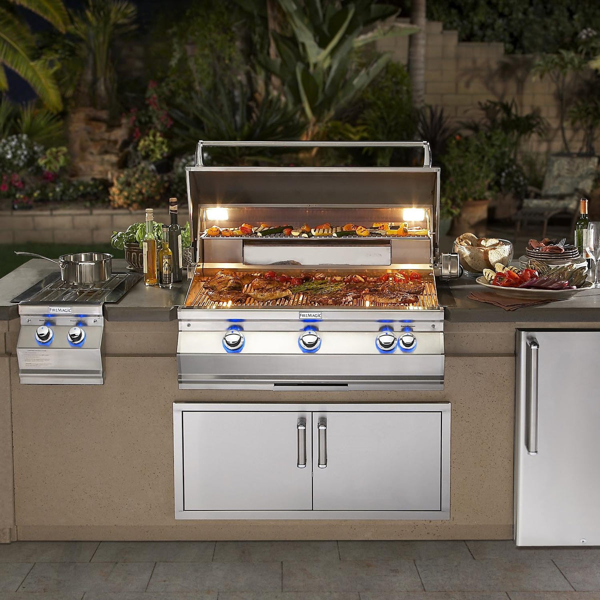 Built-in natural gas grill with open hood and lit infrared warming area