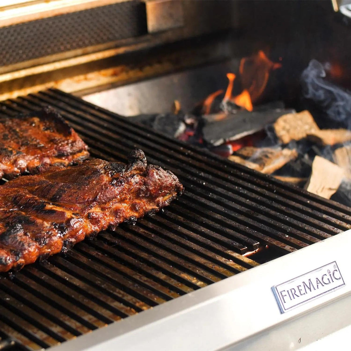 Built-in natural gas grill grates with grilled meat, flames, and visible branding strip