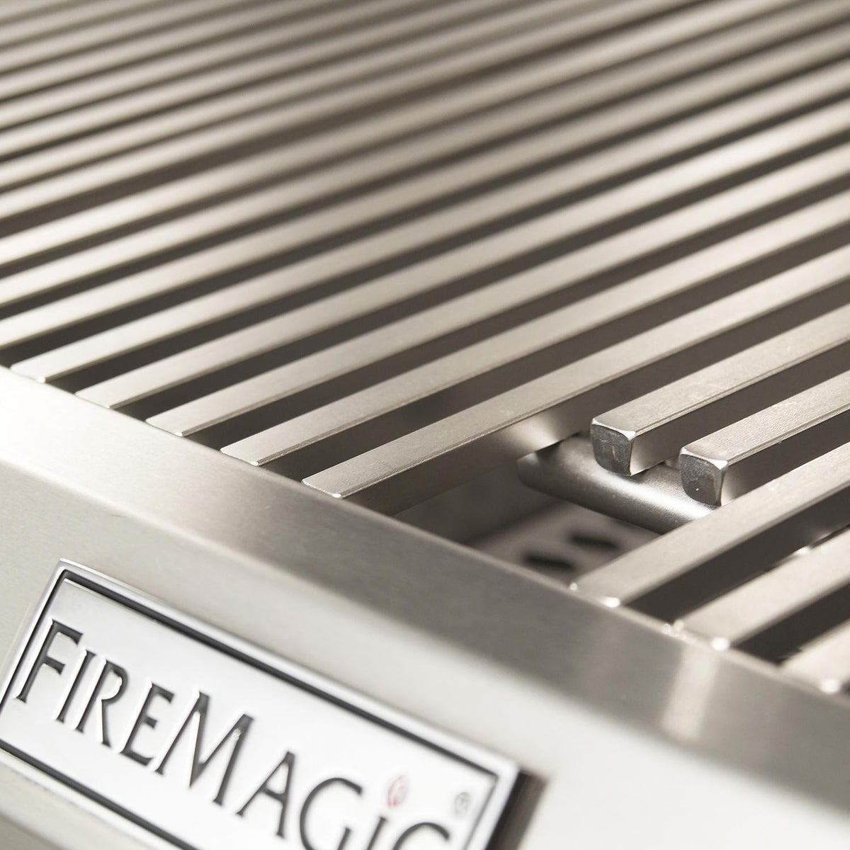 Stainless steel grill grates with FireMagic logo badge on front panel