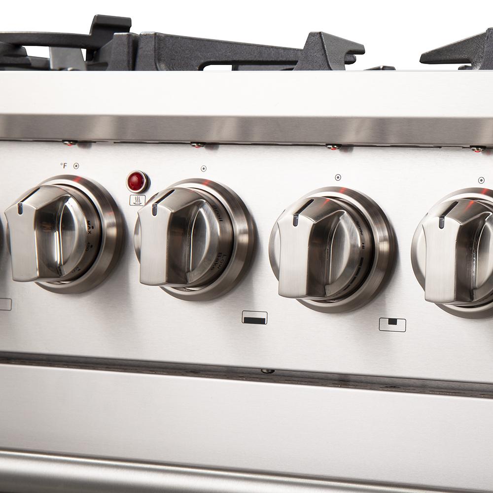 Stainless steel range control panel with four metal burner knobs and indicator lights