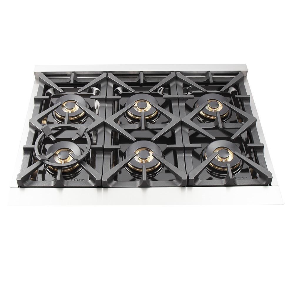 Gas cooktop with six black burner grates on a stainless steel surface