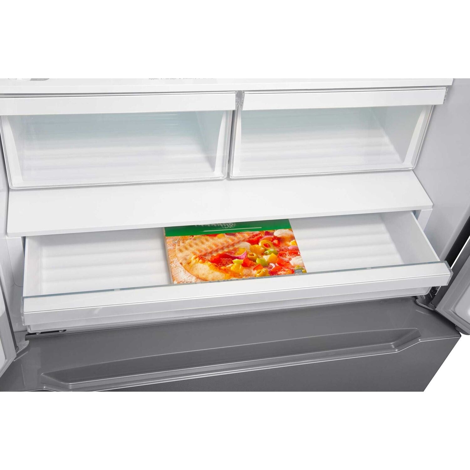 Refrigerator interior with glass shelf and pull-out drawer holding packaged food