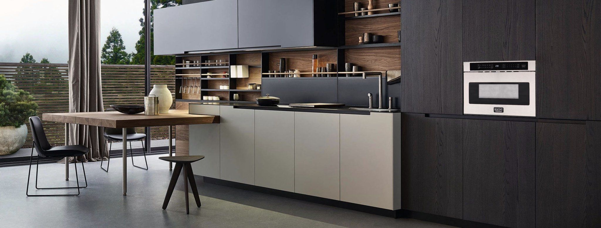 Stainless steel microwave drawer built into kitchen cabinetry with black control panel