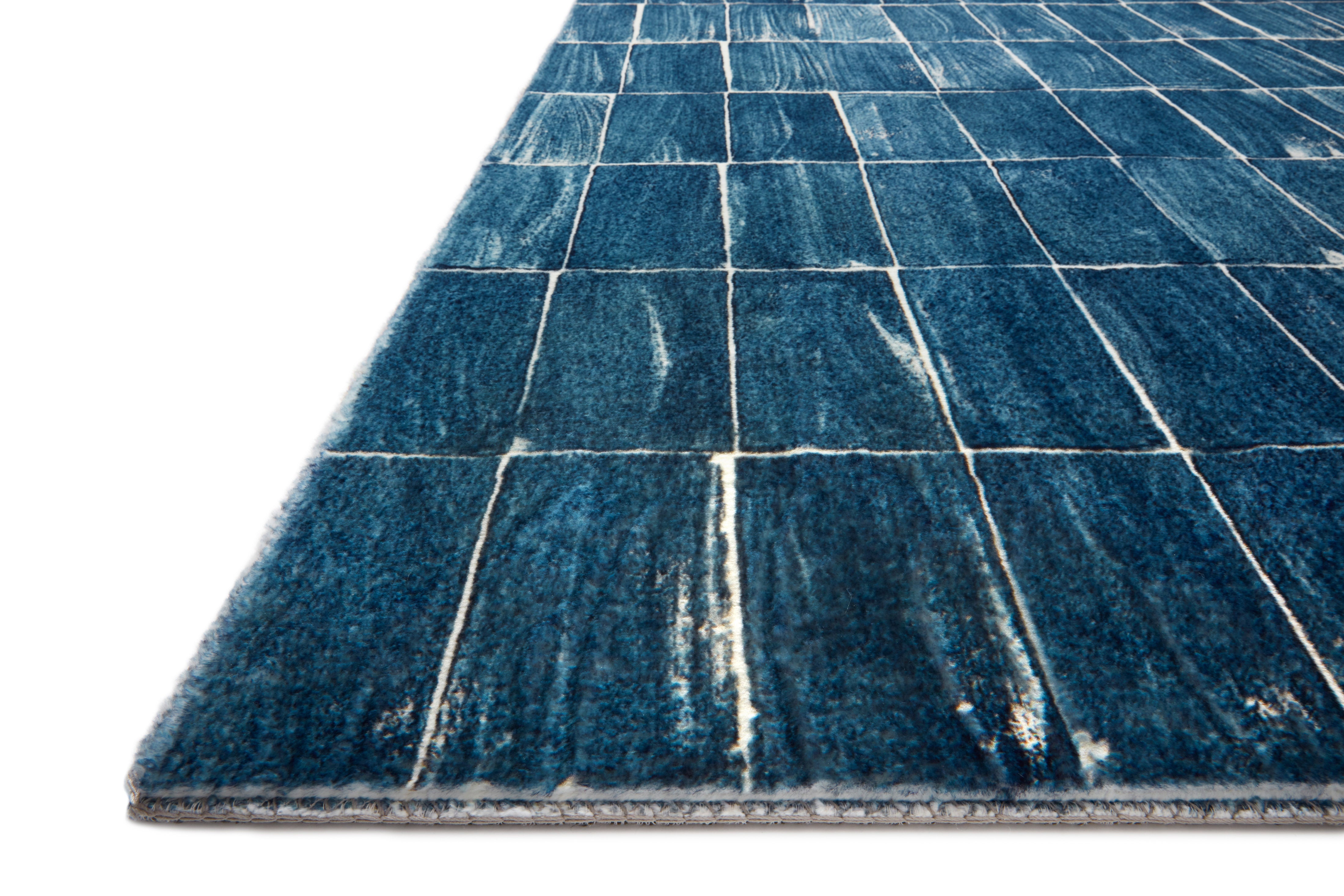 Denim and ivory grid hand-tufted rug with short fringe, angled view