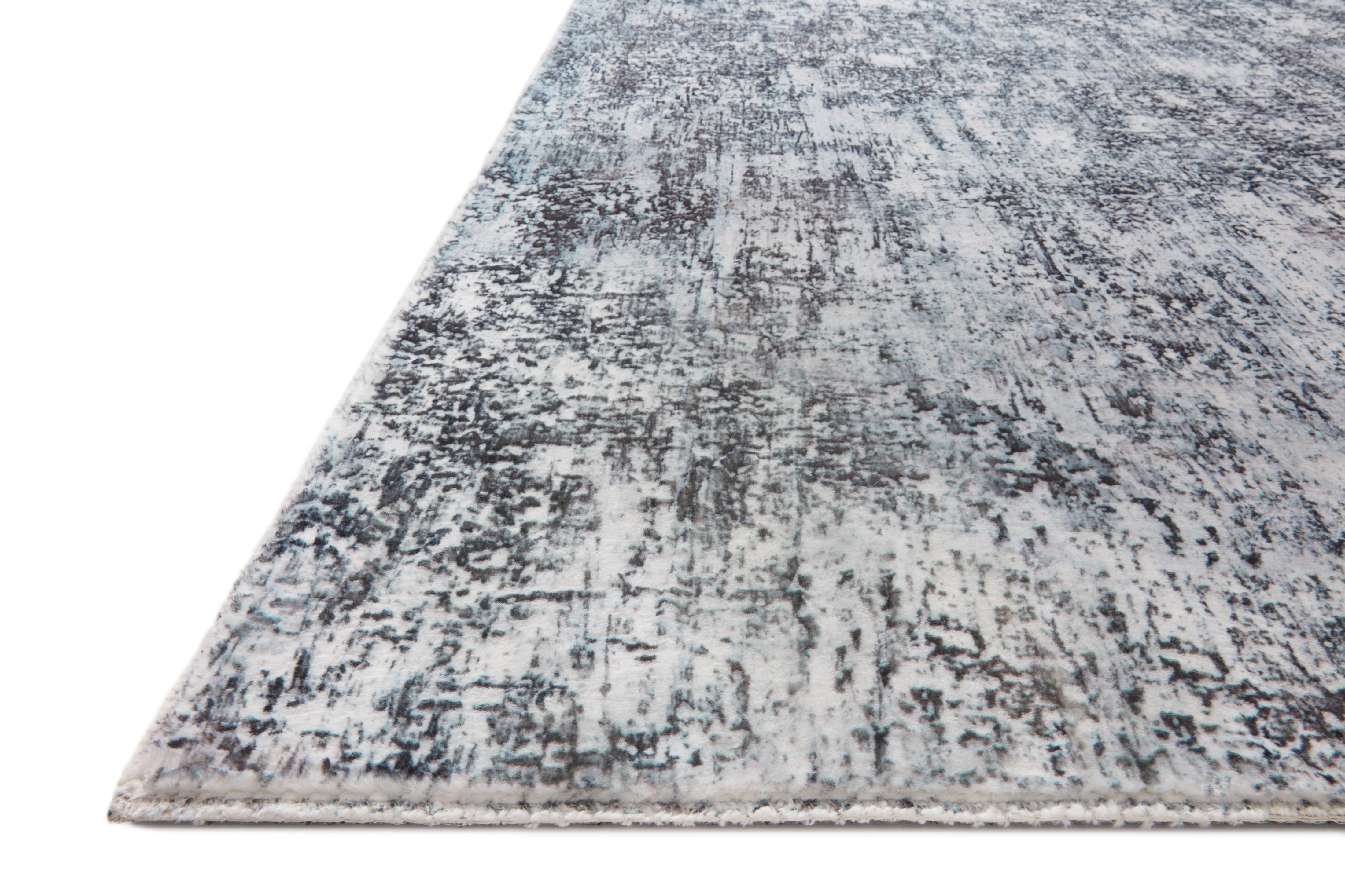 Contemporary hand-tufted rug, angled view showing distressed light gray and dark graphite