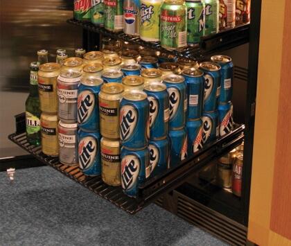 Built-in refrigerator interior with rows of canned drinks on black wire shelves