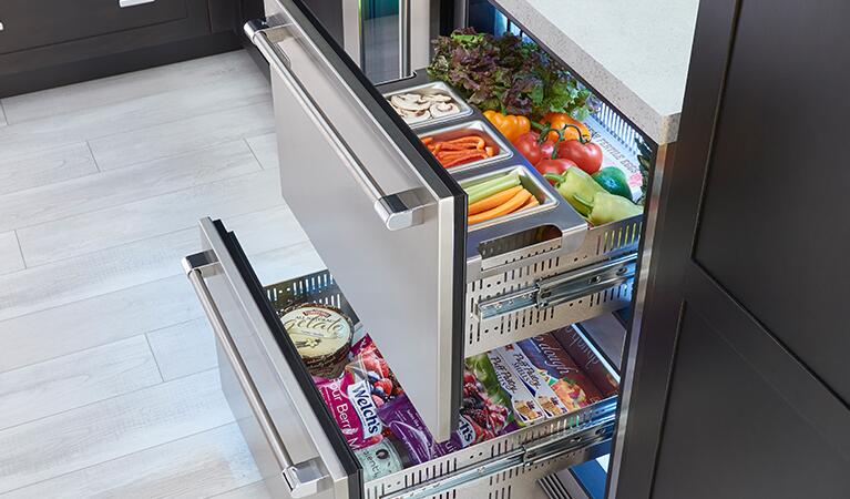Open dual-zone refrigerator showing sliding drawers and stocked wire shelves