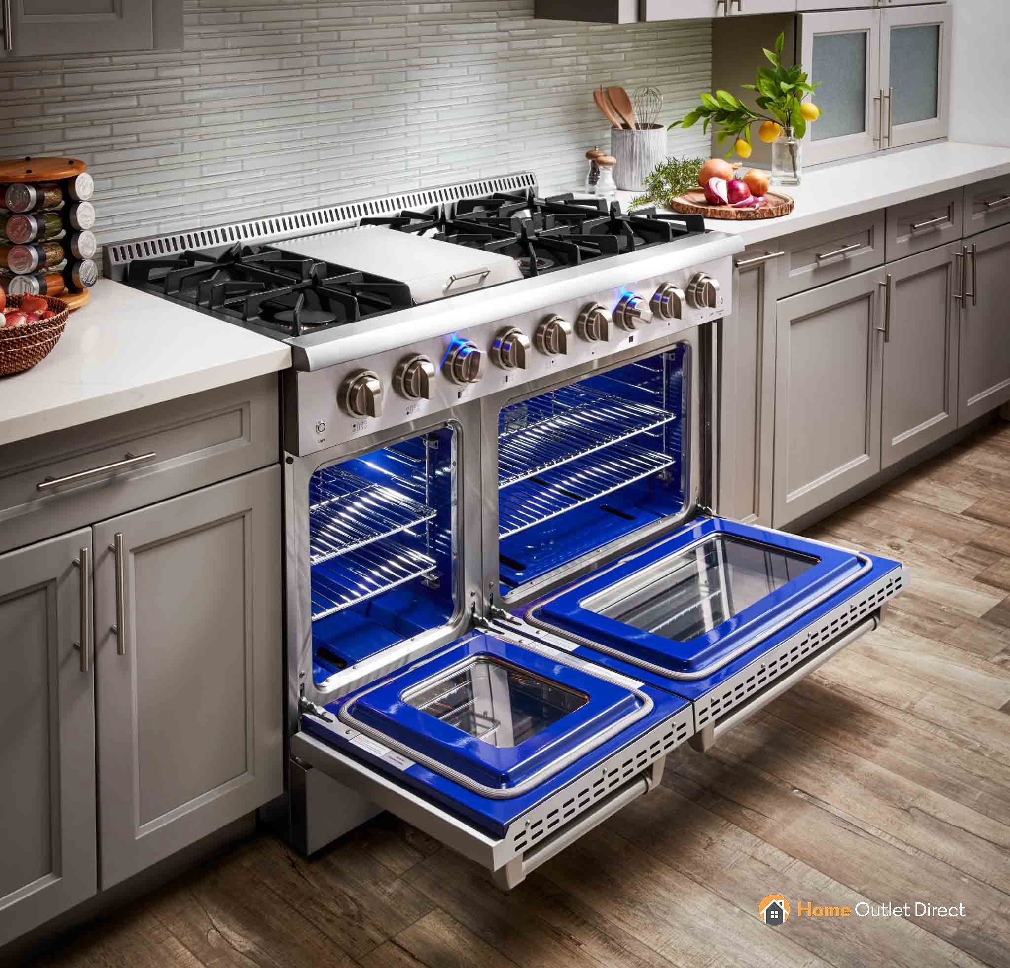 Stainless steel dual fuel range with both ovens open, blue interior lights.