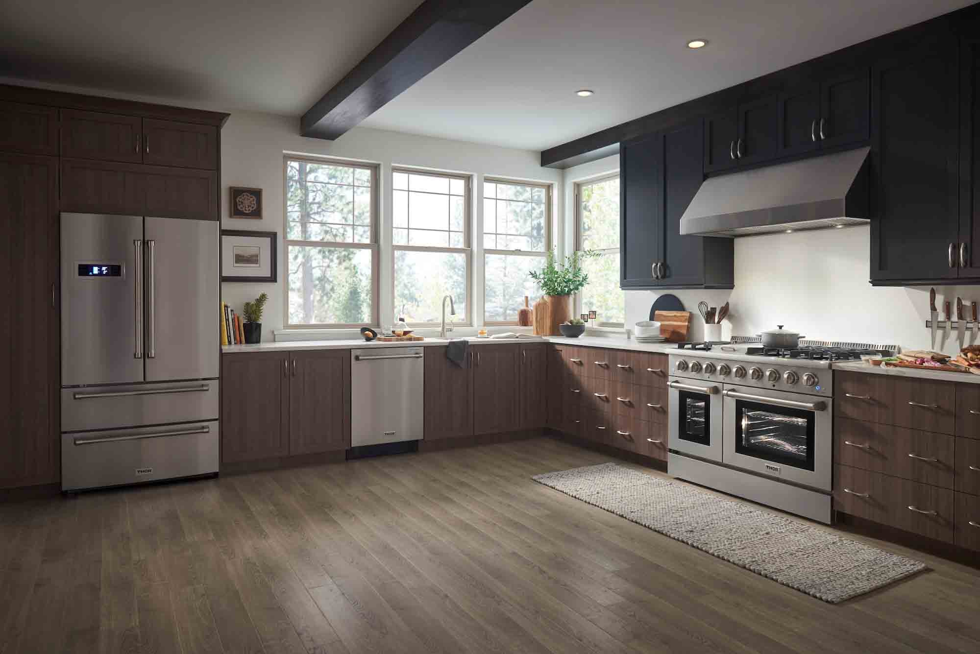 Dual fuel range and under-cabinet hood package in stainless steel, side view in kitchen.