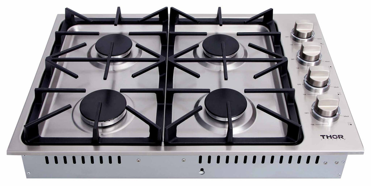 Top view of stainless gas cooktop with four burners and black cast-iron grates
