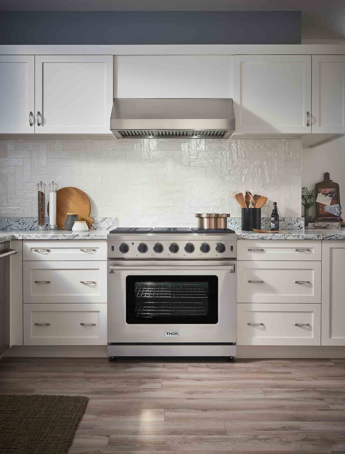 Stainless steel gas range in a kitchen with oven door and burner controls