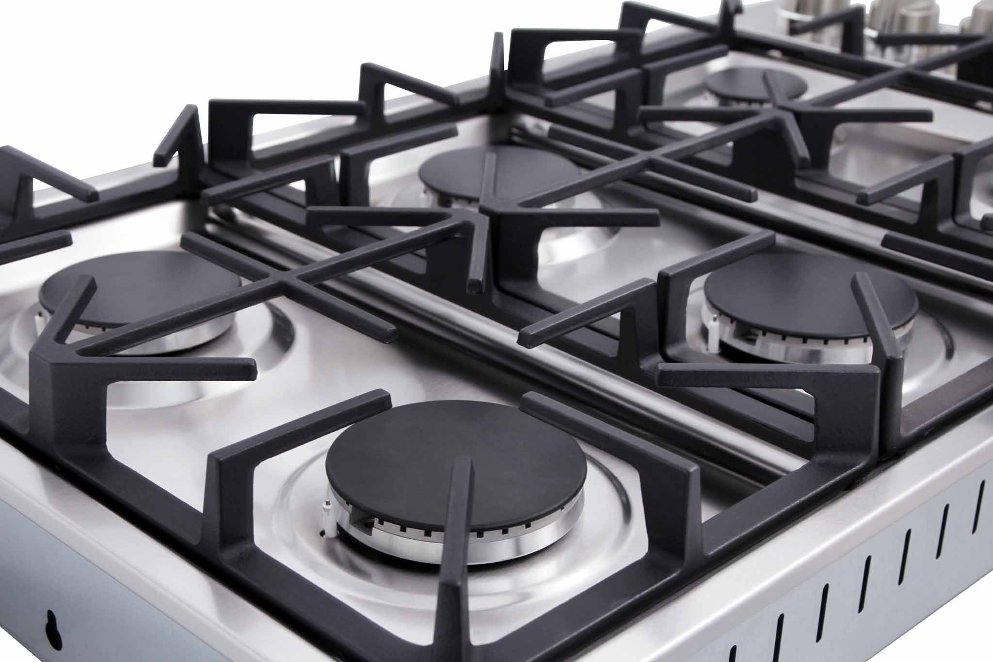 Stainless gas cooktop burner with black grate and circular burner cap on metal surface