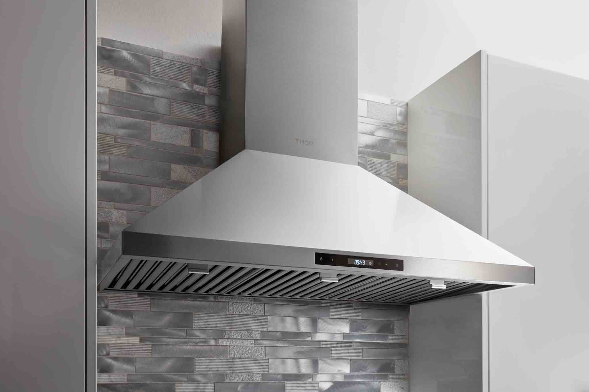 Thor Kitchen stainless range hood with side chimney and vent grille over cooktop