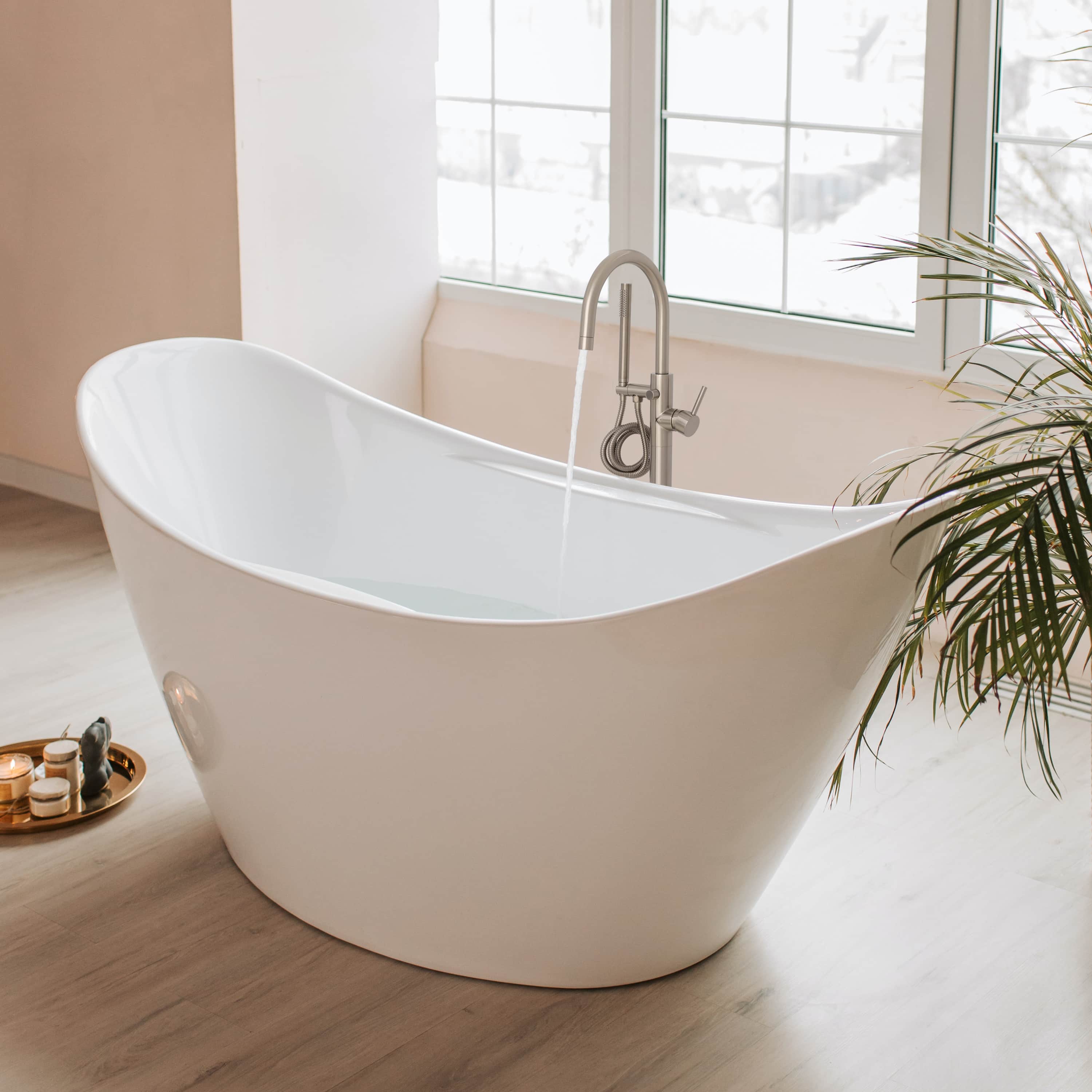 Bathtub deck filler with curved spout in brushed nickel and matching control knobs.