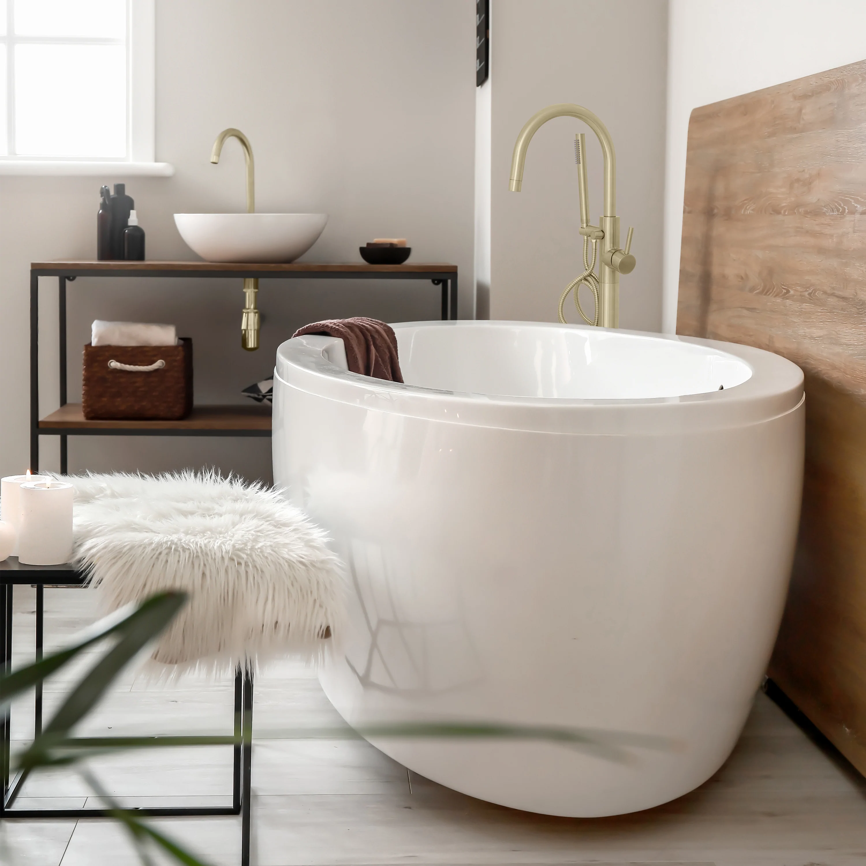 Champagne bronze tub filler with single lever and curved spout over white bathtub