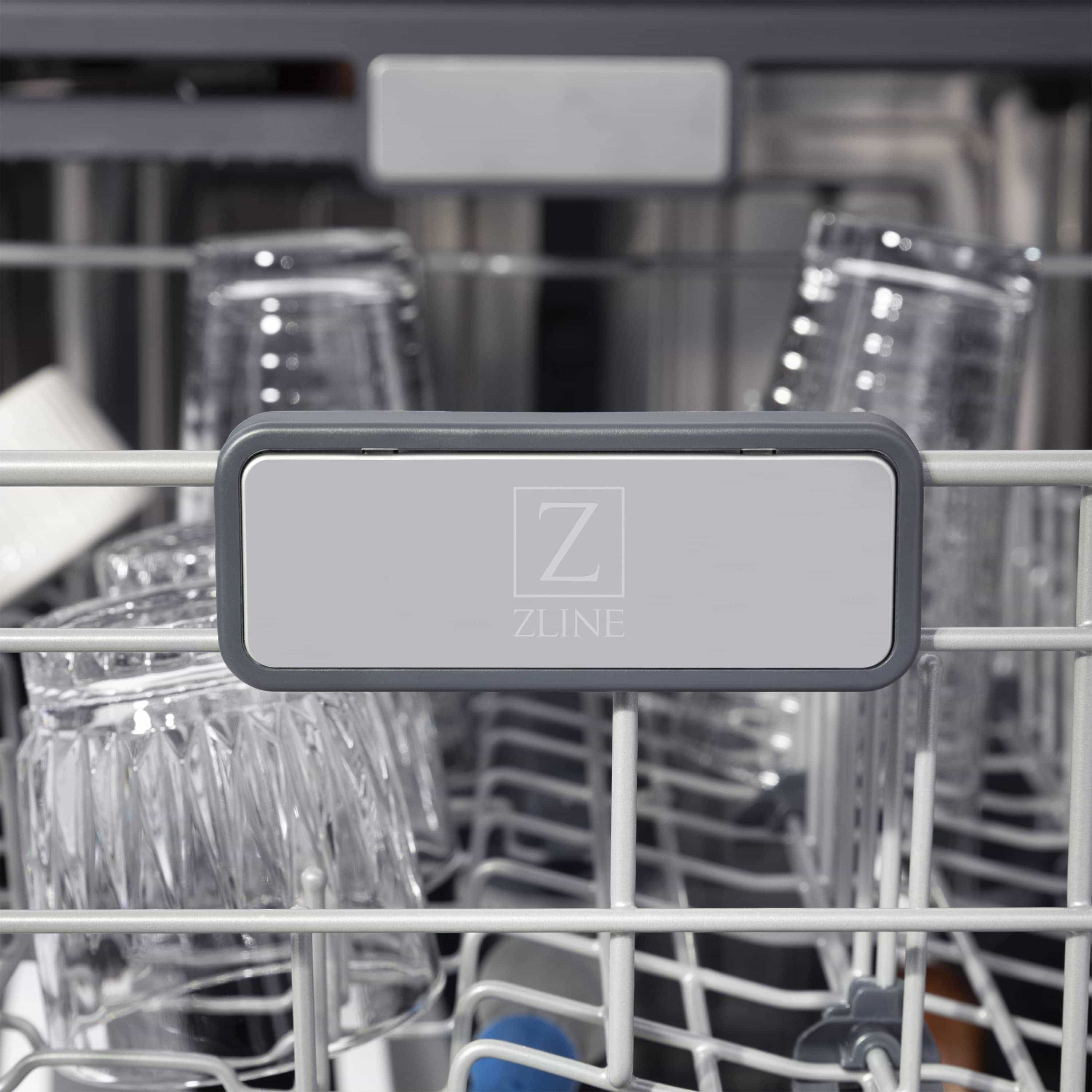 Dishwasher interior with rack and gray control panel area in the center