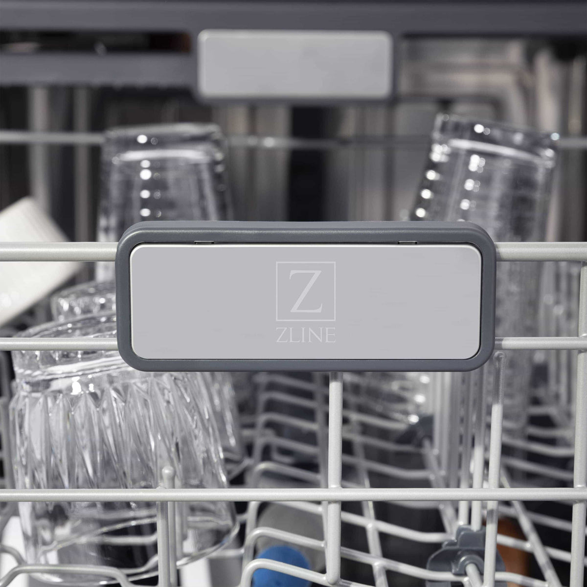 Dishwasher interior rack with glassware and dispenser panel on upper rail