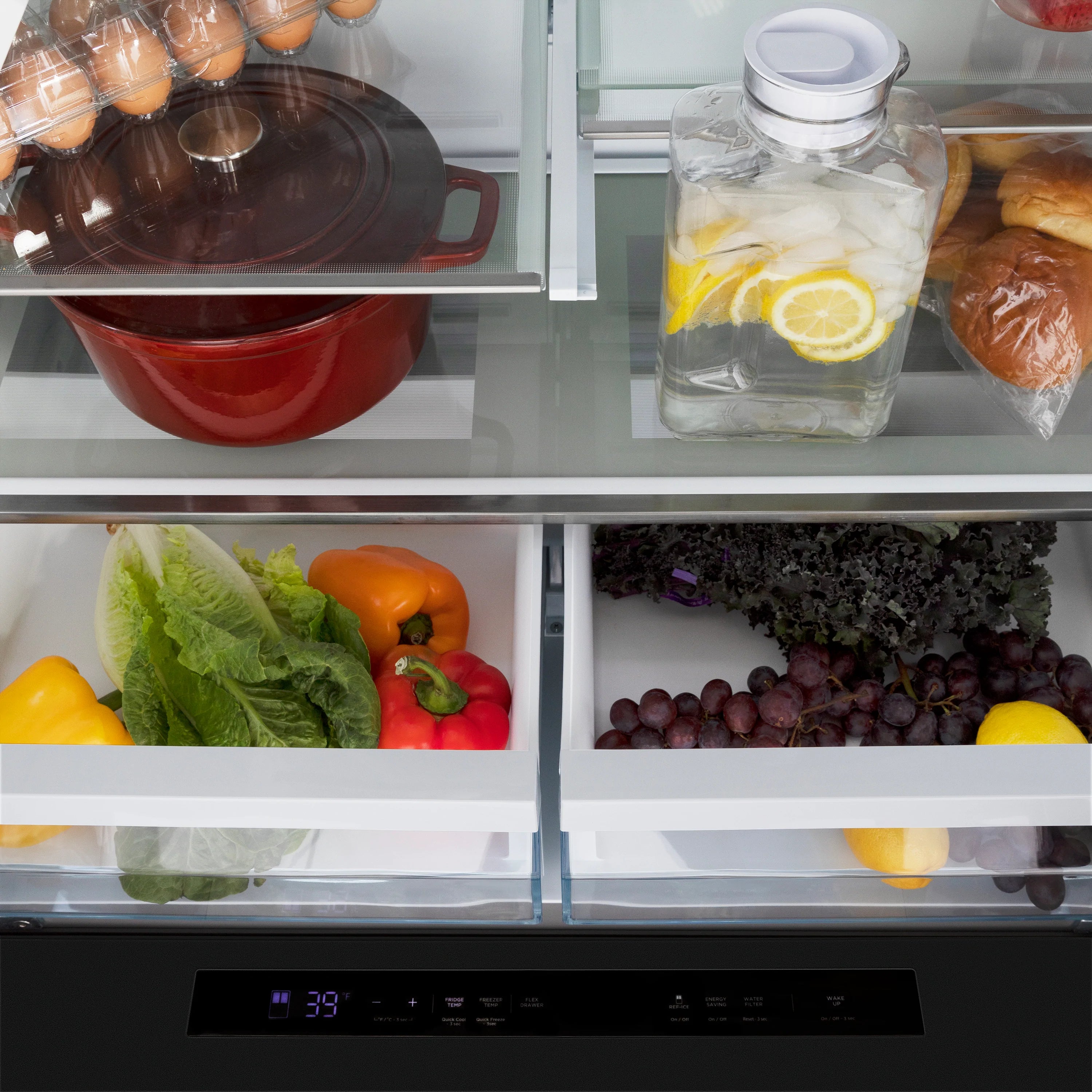 Refrigerator door and crisper with vegetables, fruit, and a covered container