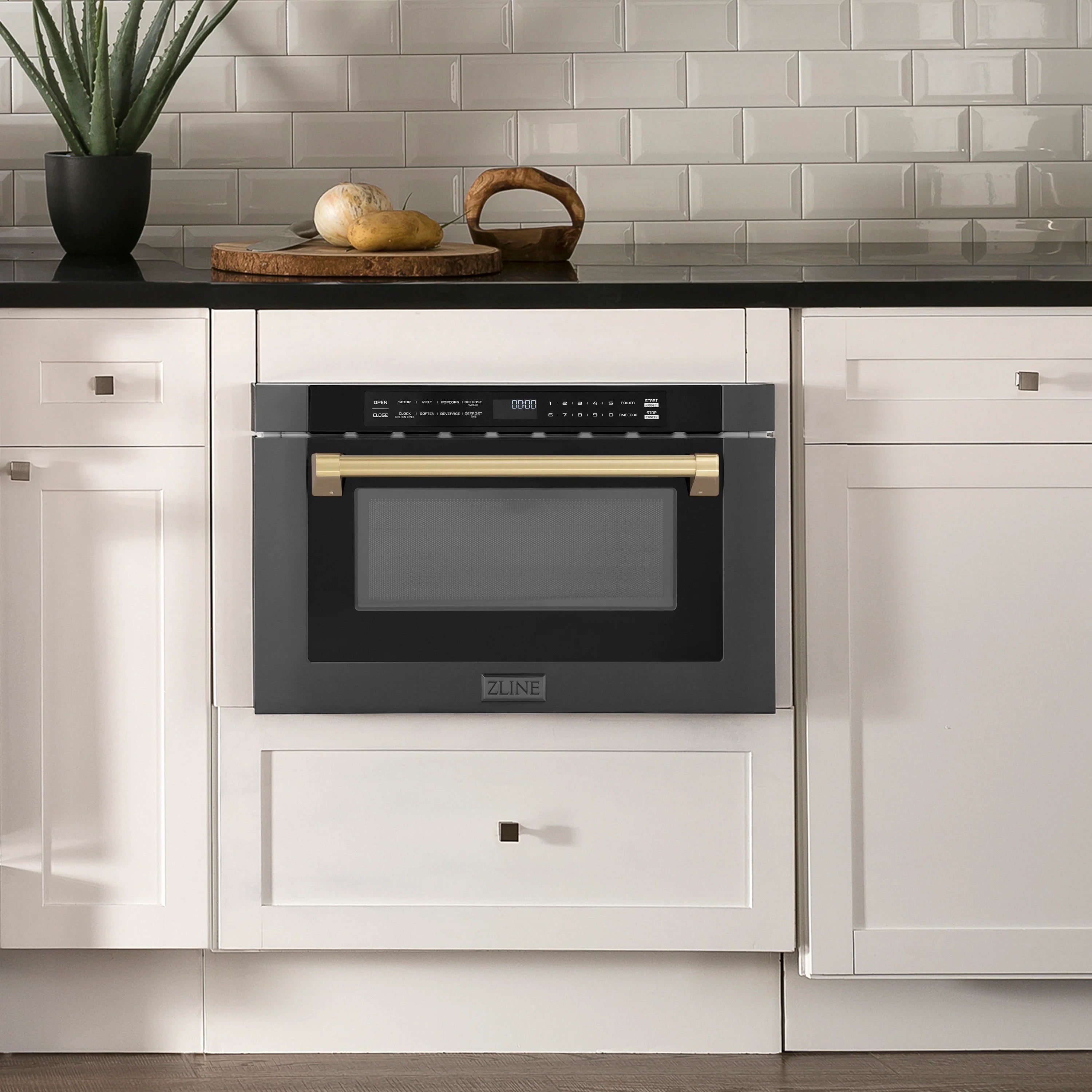 Built-in black stainless steel microwave drawer with champagne bronze handle bars