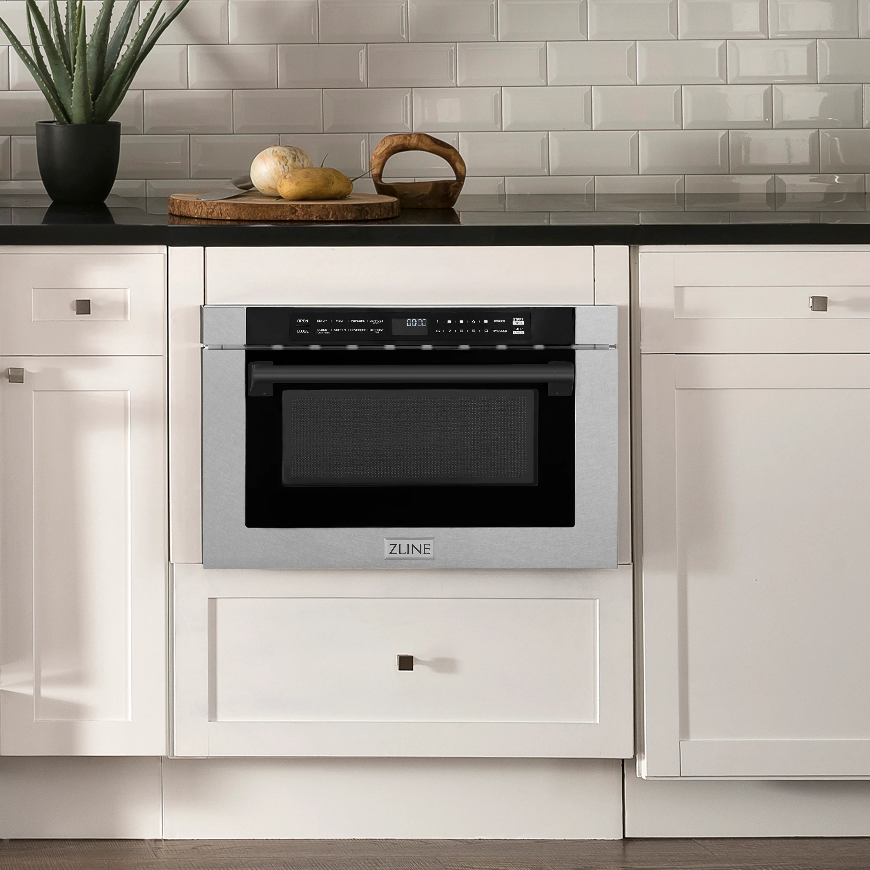 Built-in microwave drawer installed in cabinetry, stainless face with dark glass window