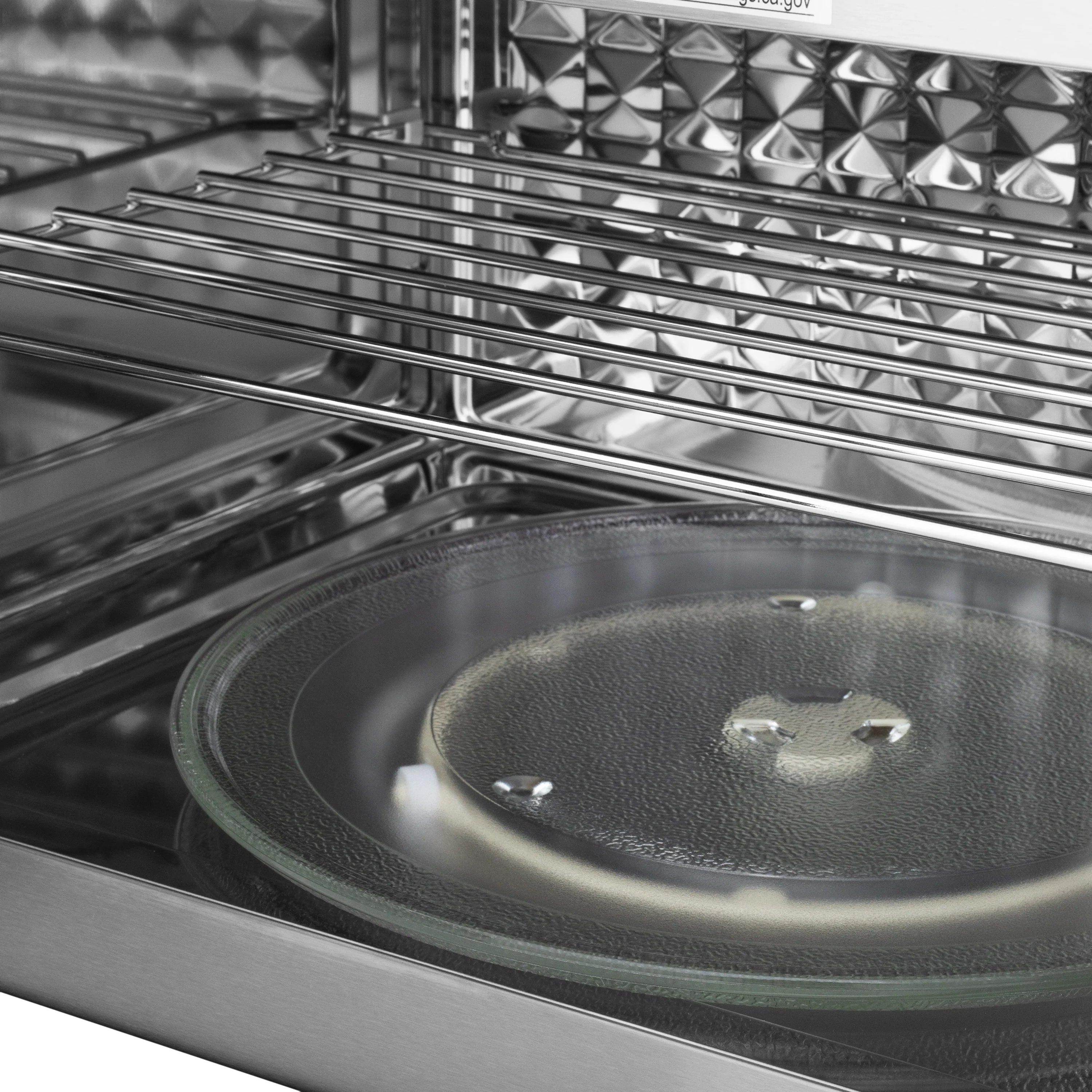 Gas range oven interior with wire rack and black cooktop glass window