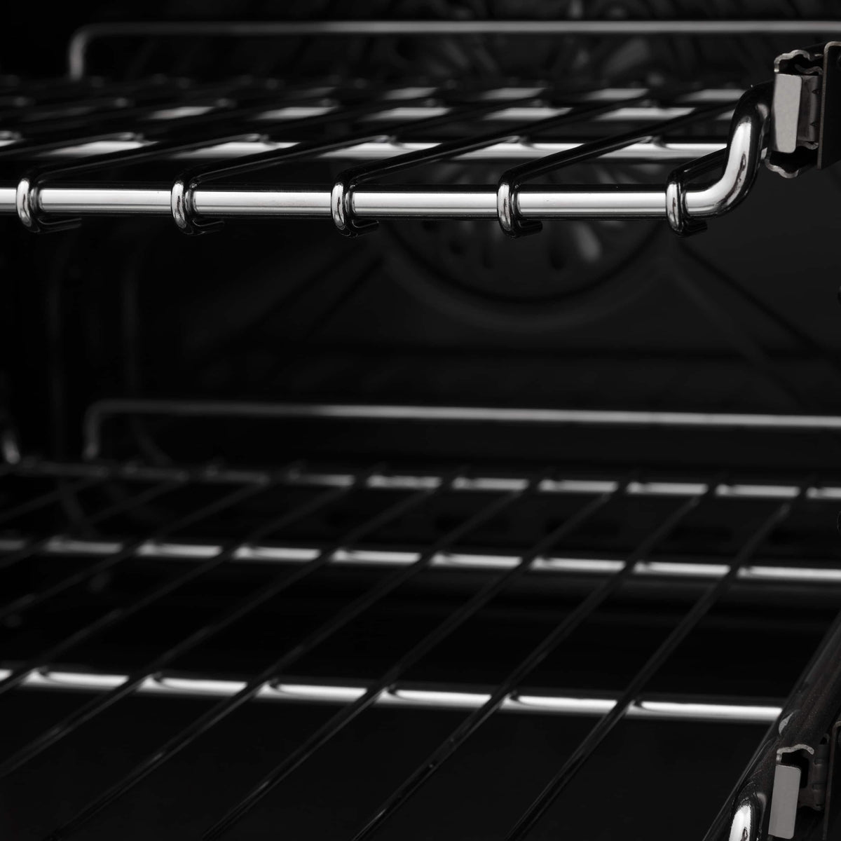 Stainless oven racks and broil elements inside a black electric oven