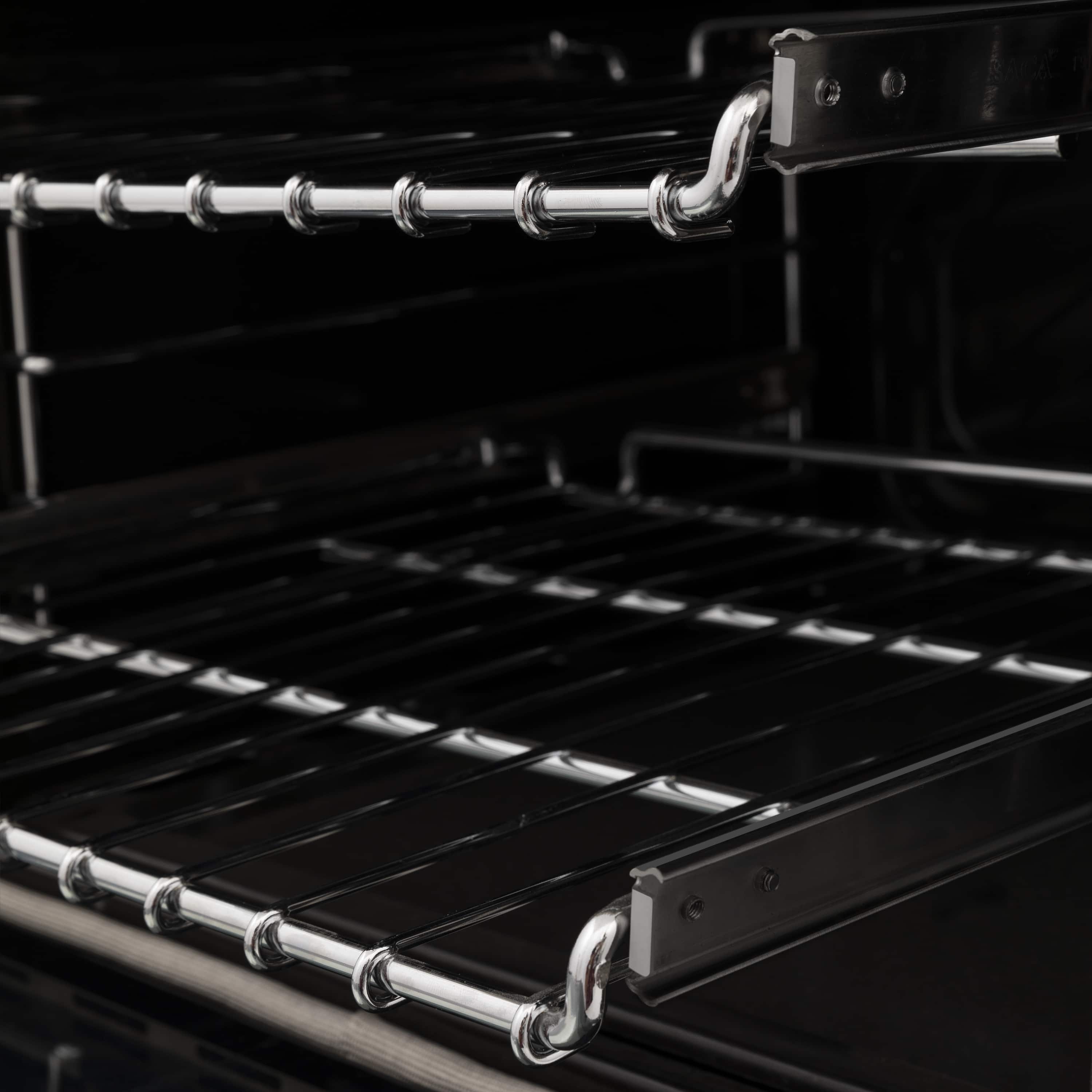 Oven interior with chrome wire racks and heating elements in a black range