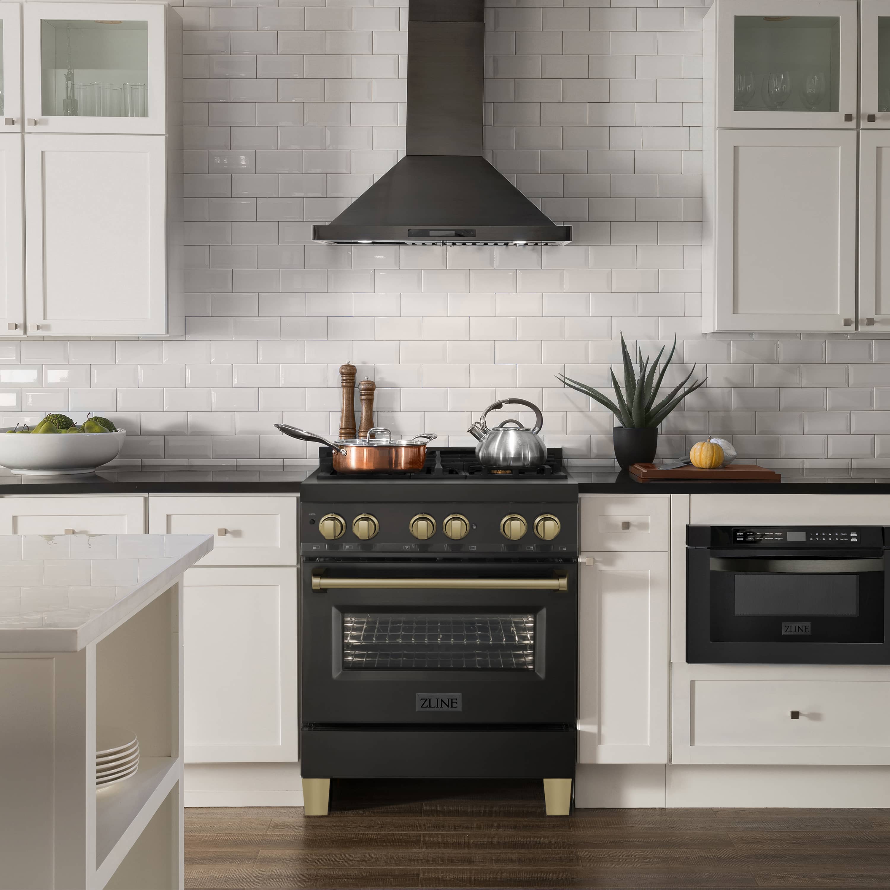 Black dual fuel range with gas cooktop and electric oven, bronze knobs and trim