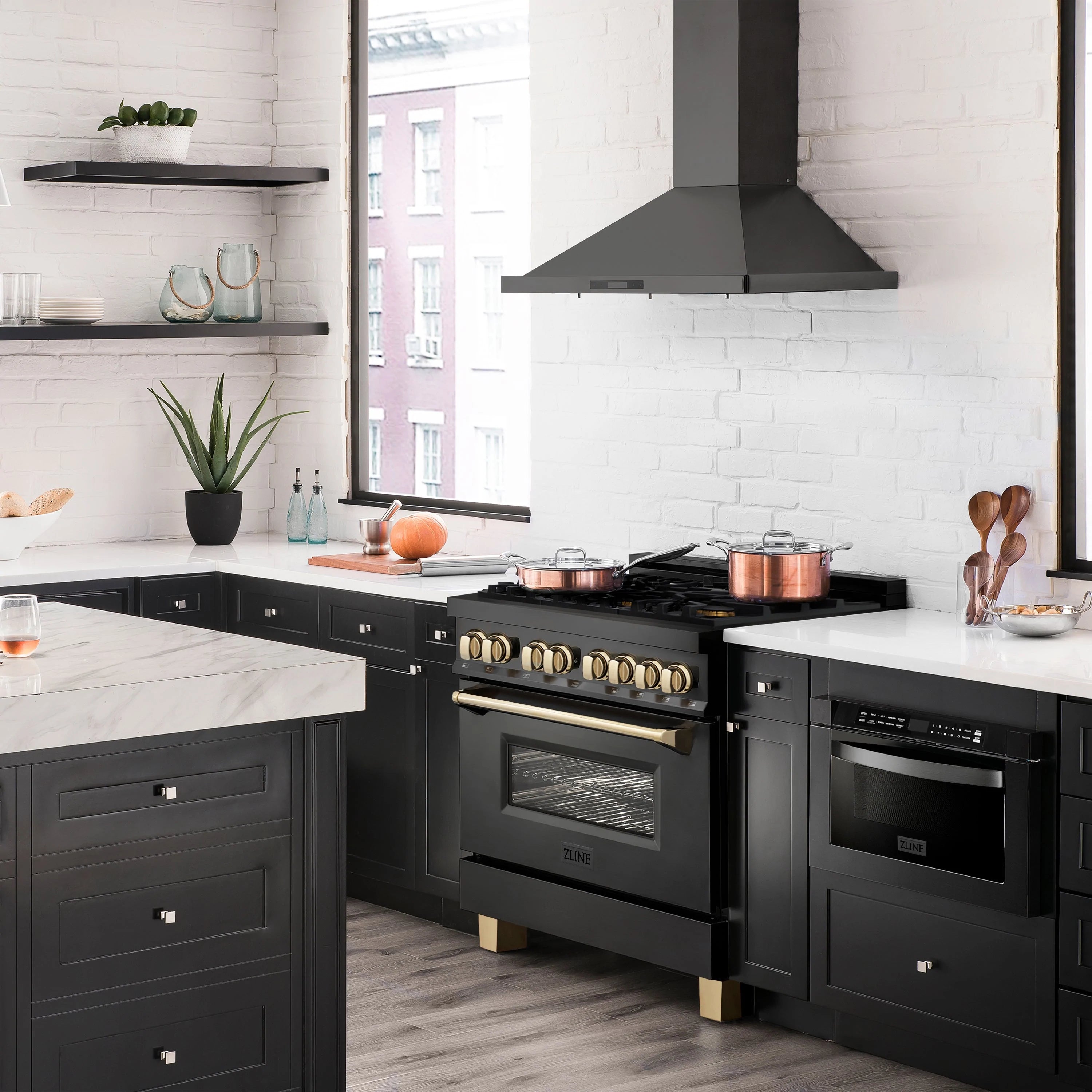 Black kitchen range with wall-mounted hood and gold-trim controls