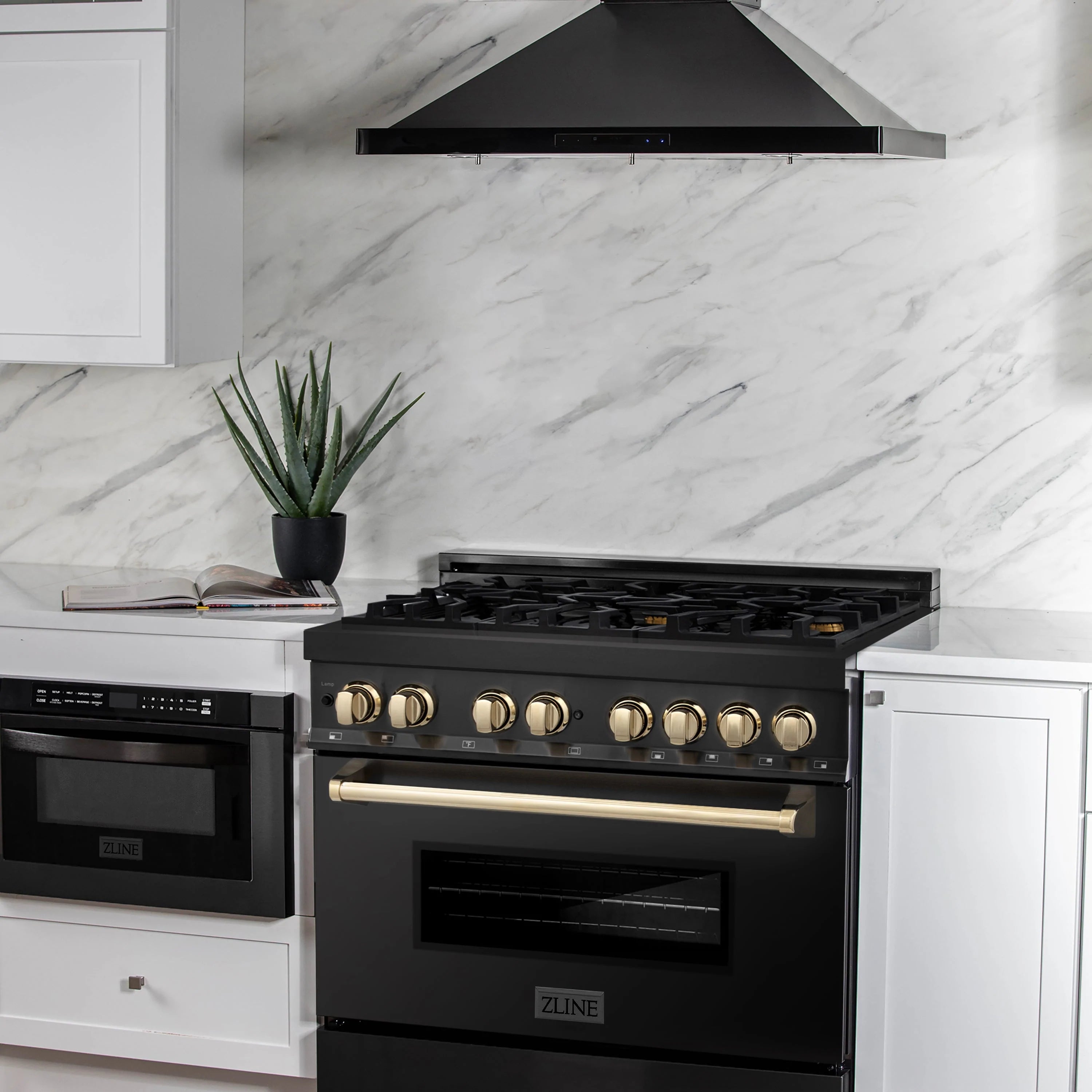 Black dual fuel range with wall-mounted hood and gold control knobs