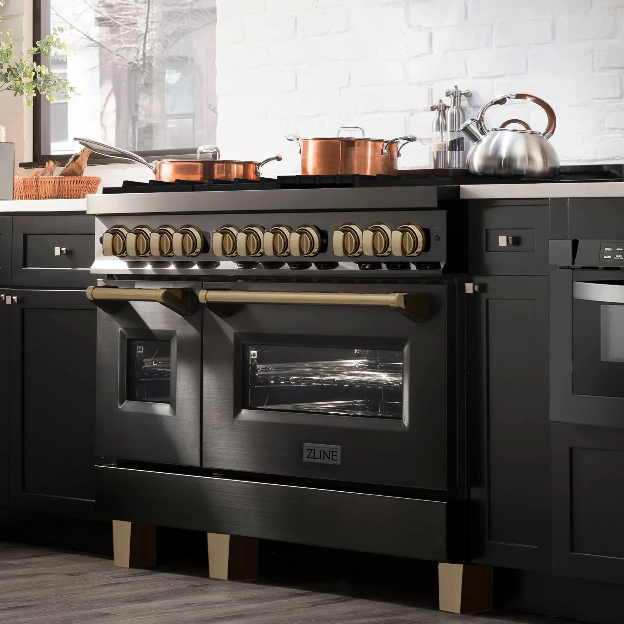 Black dual-fuel range with dual ovens and champagne bronze control knobs