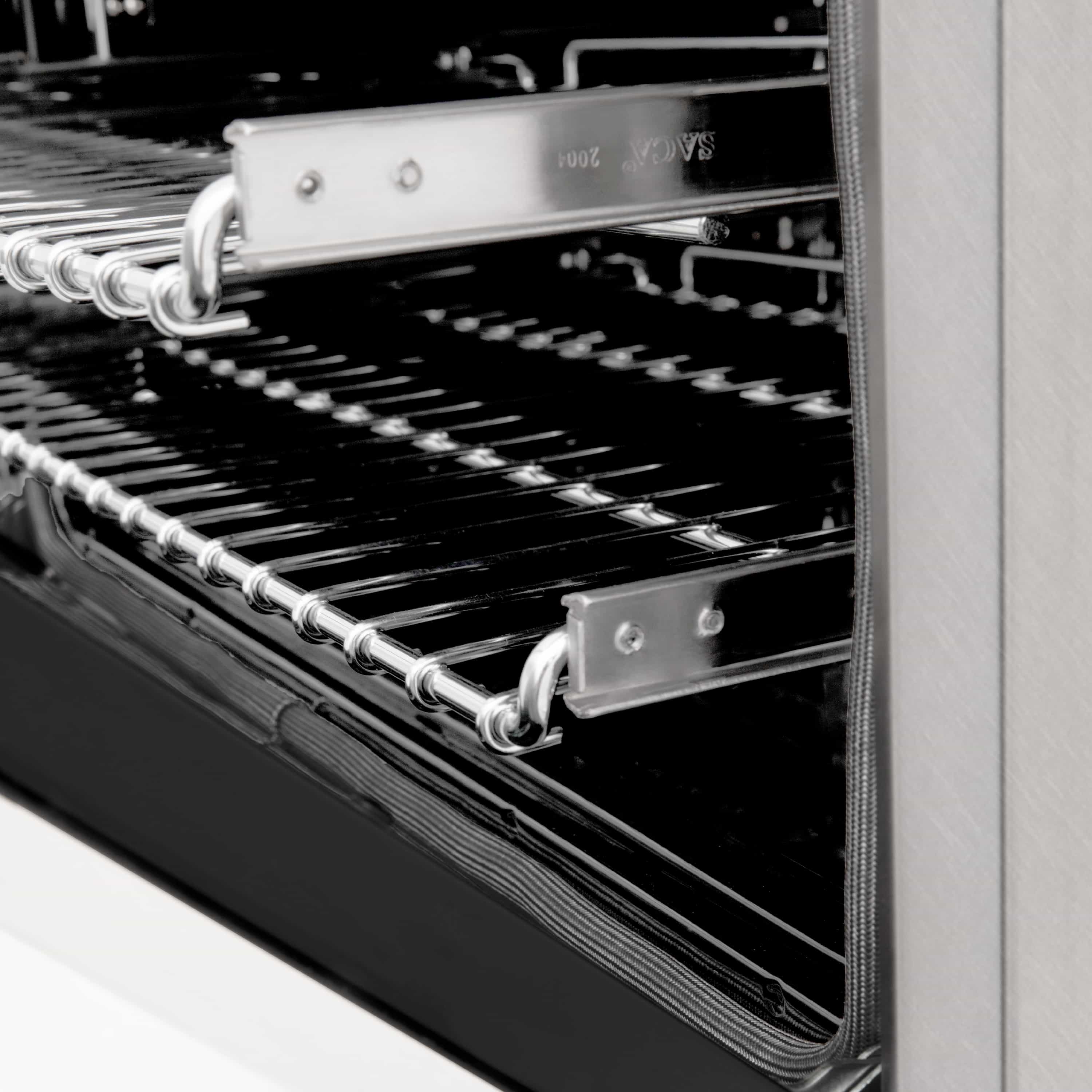 Built-in oven rack and broiler rails with chrome trim inside a dark oven cavity