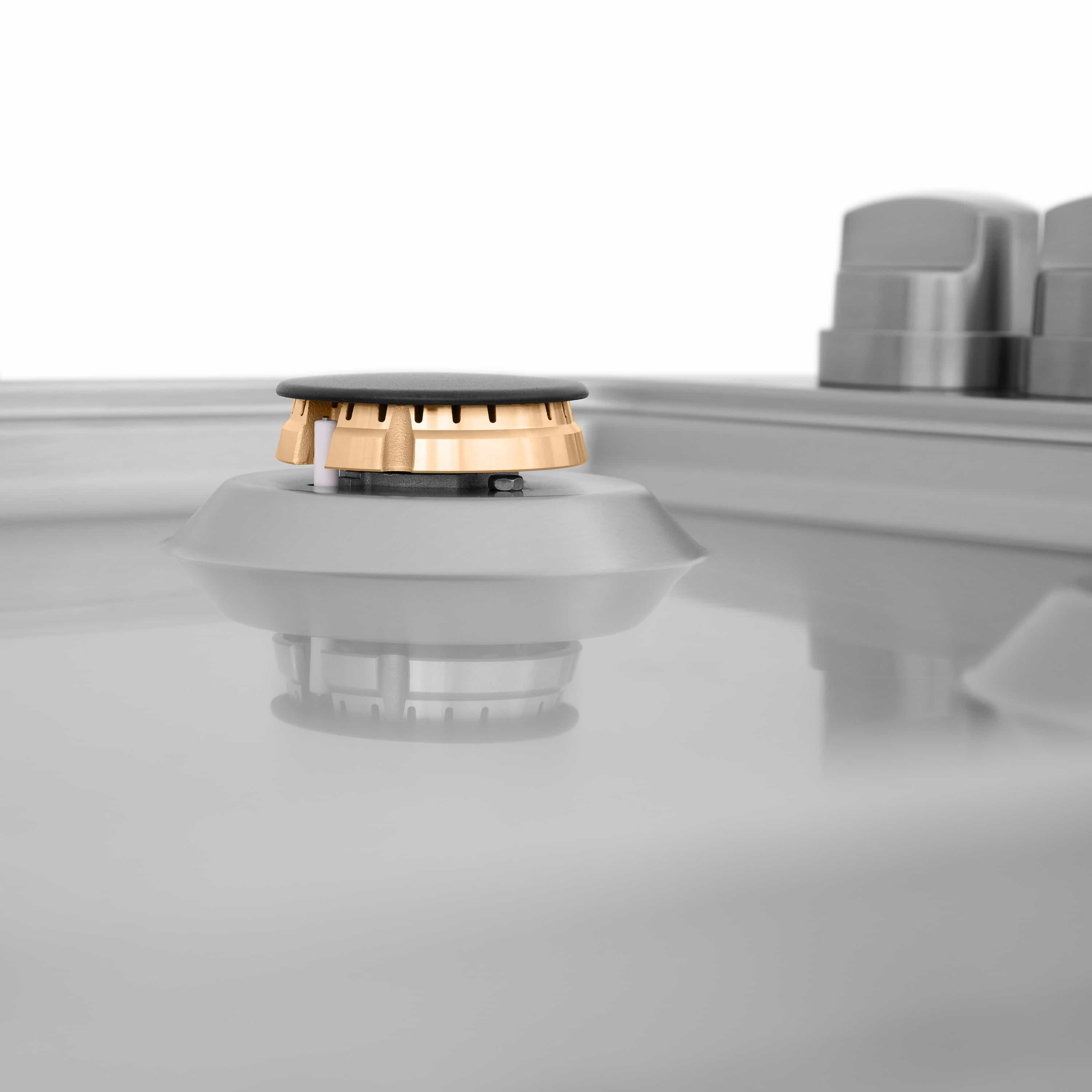 Isolated gas cooktop burner cap with brass base ring and plastic inner parts
