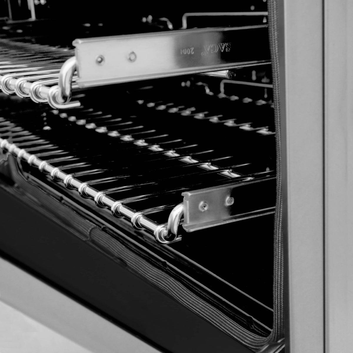 Oven interior with multiple racks and chrome rails, showing black cooking cavity